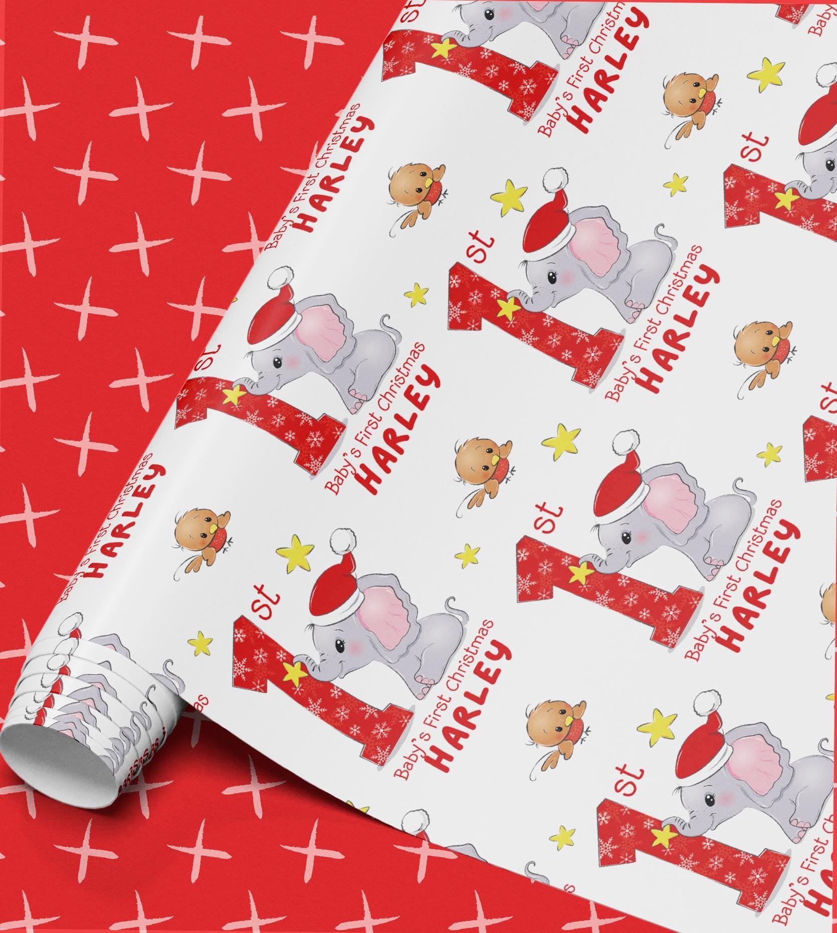 Roll of personalised Baby's First Christmas wrapping paper with an elephant in a Santa hat design and custom name printed throughout.