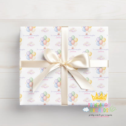 Detail shot of the personalised name printed within the pastel balloon wrapping paper design