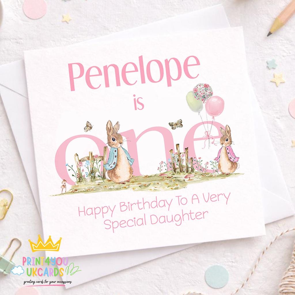 Front view of the pink bunny and pastel balloon 1st birthday keepsake card on a plain background.
