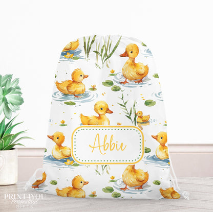 Personalised duck print drawstring PE bag with a child's name printed on the front, yellow ducklings among lily pads