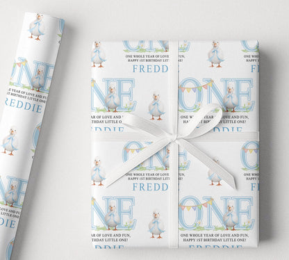 Personalised blue duck first birthday wrapping paper with custom name, pastel blue design and duck illustrations.