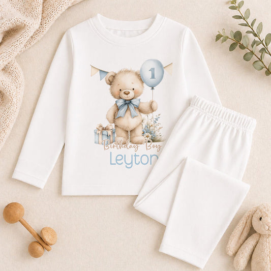 Personalised blue and beige teddy bear pyjamas for a baby boy's 1st birthday