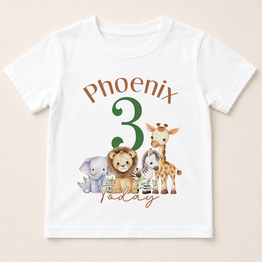 A white t-shirt with a graphic design featuring a group of cartoon animals, including a lion, giraffe, elephant, and zebra, along with the text "Phoenix 3 Today".
