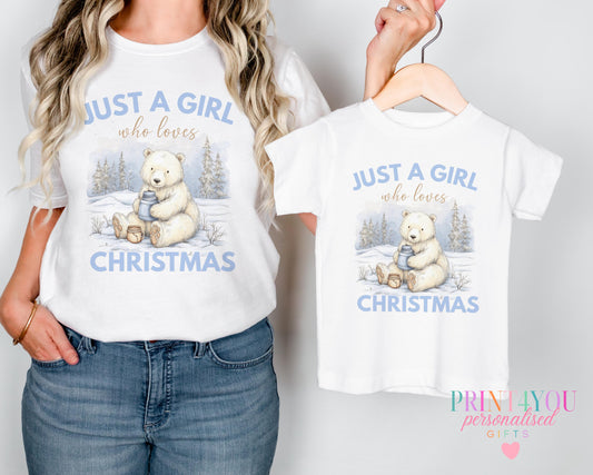 Mother and daughter wearing matching "Just a Girl Who Loves Christmas" personalised t-shirts with a polar bear design