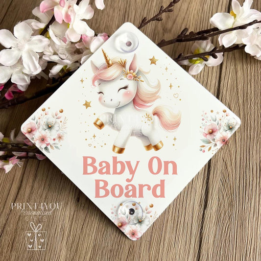 Baby on Board car sign, square aluminium plaque printed with a watercolour unicorn, pink flowers and gold stars above Baby On Board