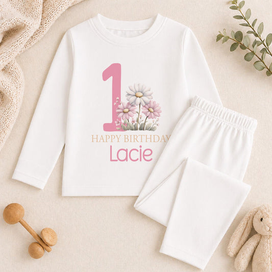 Personalised pink flower 1st birthday pyjamas for baby girls, printed with a custom name