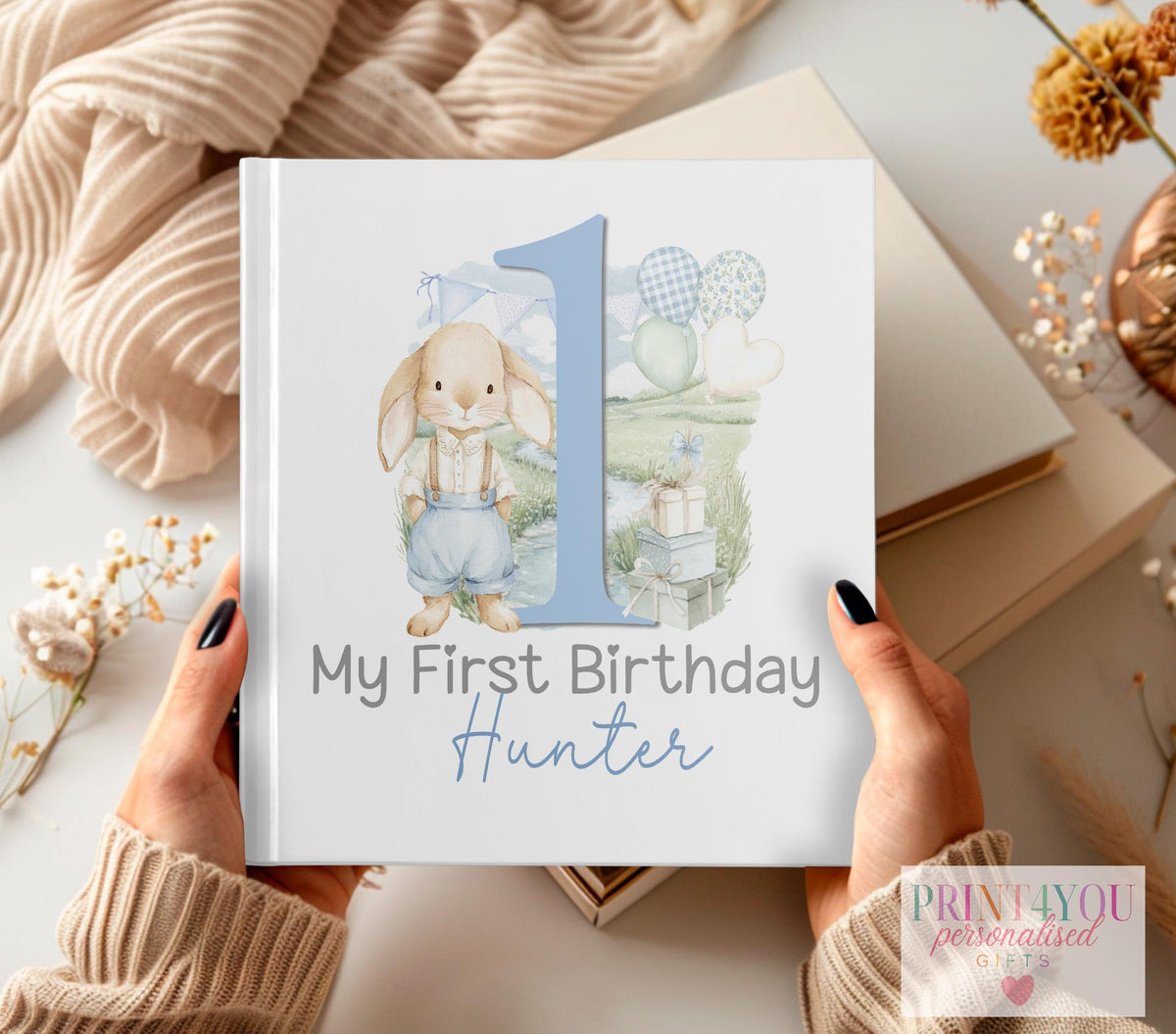 Personalised first birthday photo album with blue rabbit and balloons design and custom name on the cover