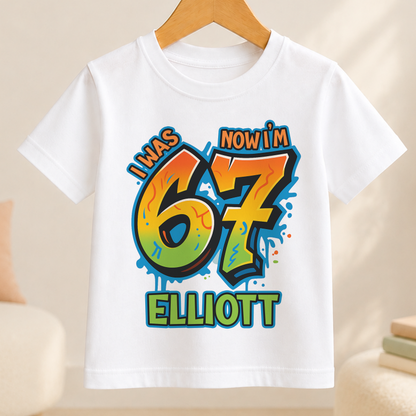 White t-shirt with bold graffiti-style number 7 design personalised with the name Elliott for a boy's 7th birthday