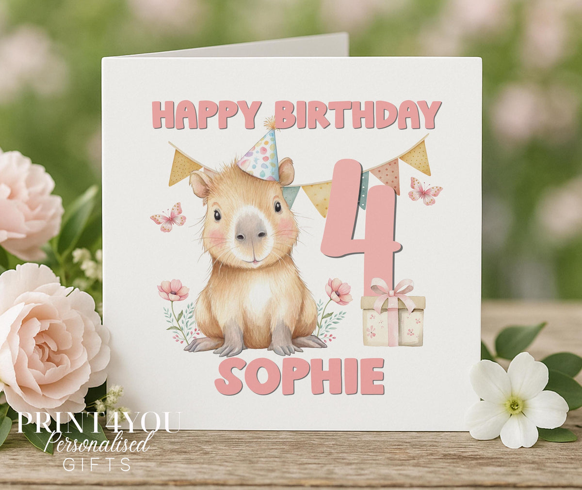 Personalised capybara birthday card with party hat design and pastel bunting, 6x6 inch card front