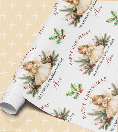 Rolled sheet of personalised angel Christmas wrapping paper printed with a name and Happy Christmas