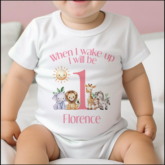 Personalised pink safari 1st birthday bib, printed with When I Wake Up I Will Be One lettering and baby's name.