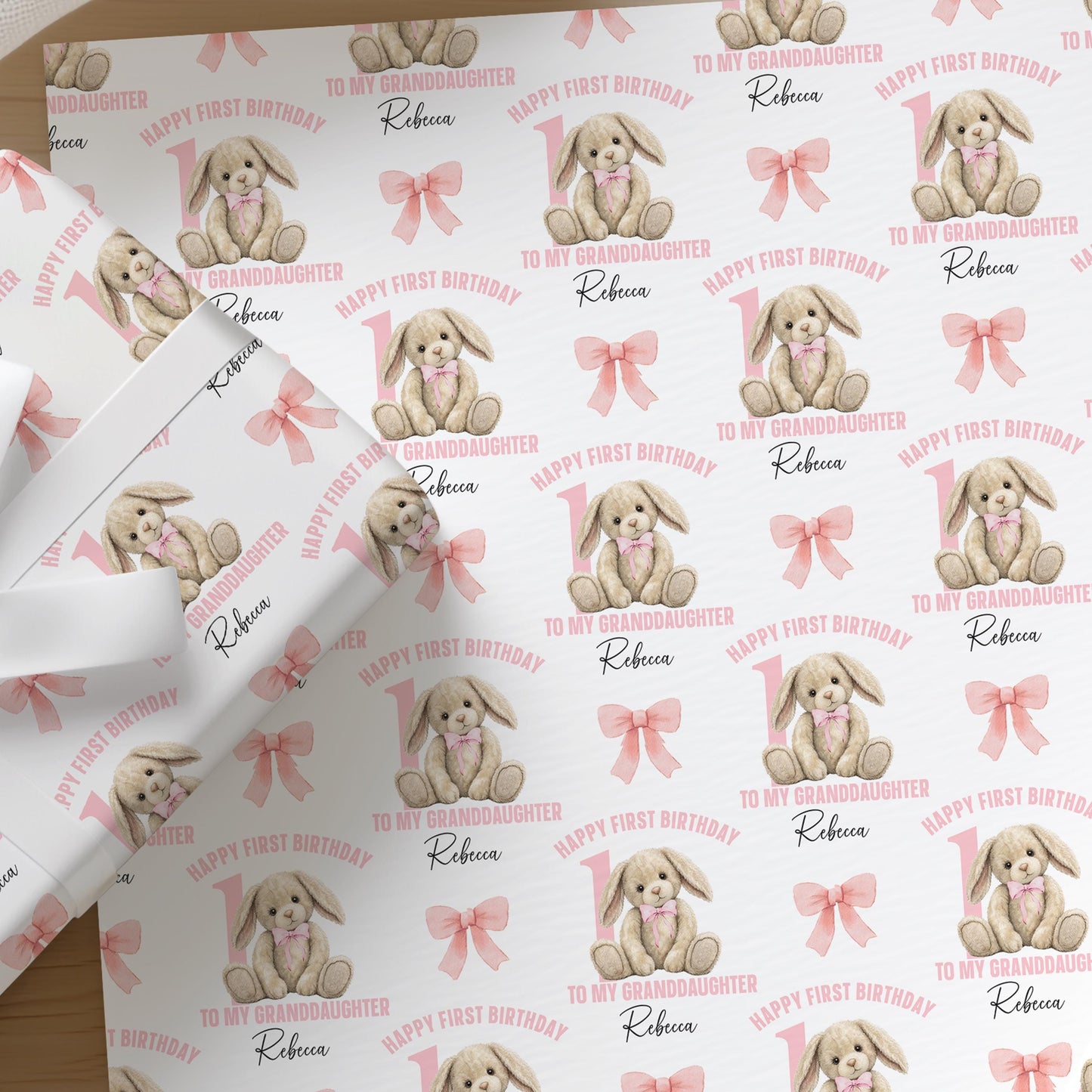 Repeating pattern of a pink baby rabbit design on personalised wrapping paper for a girl's 1st birthday