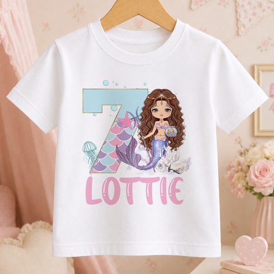 A white t-shirt with a mermaid graphic and the name "Lottie" printed on it.