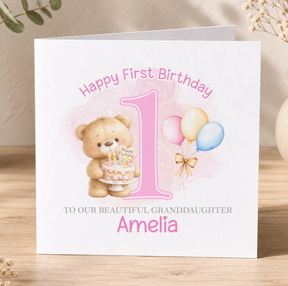 Personalised birthday card for Amelia, featuring a teddy bear holding a birthday cake and balloons, with the text Happy First Birthday to our beautiful Granddaughter Amelia.