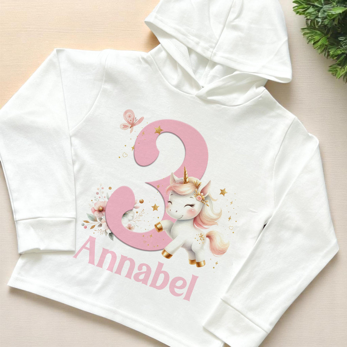 Children's hoodie printed with a colourful unicorn design and personalised name