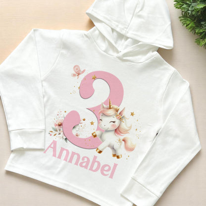 Children's hoodie printed with a colourful unicorn design and personalised name