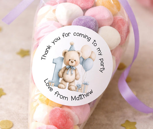 Round glossy blue teddy bear stickers printed with a child's name for party bag favours