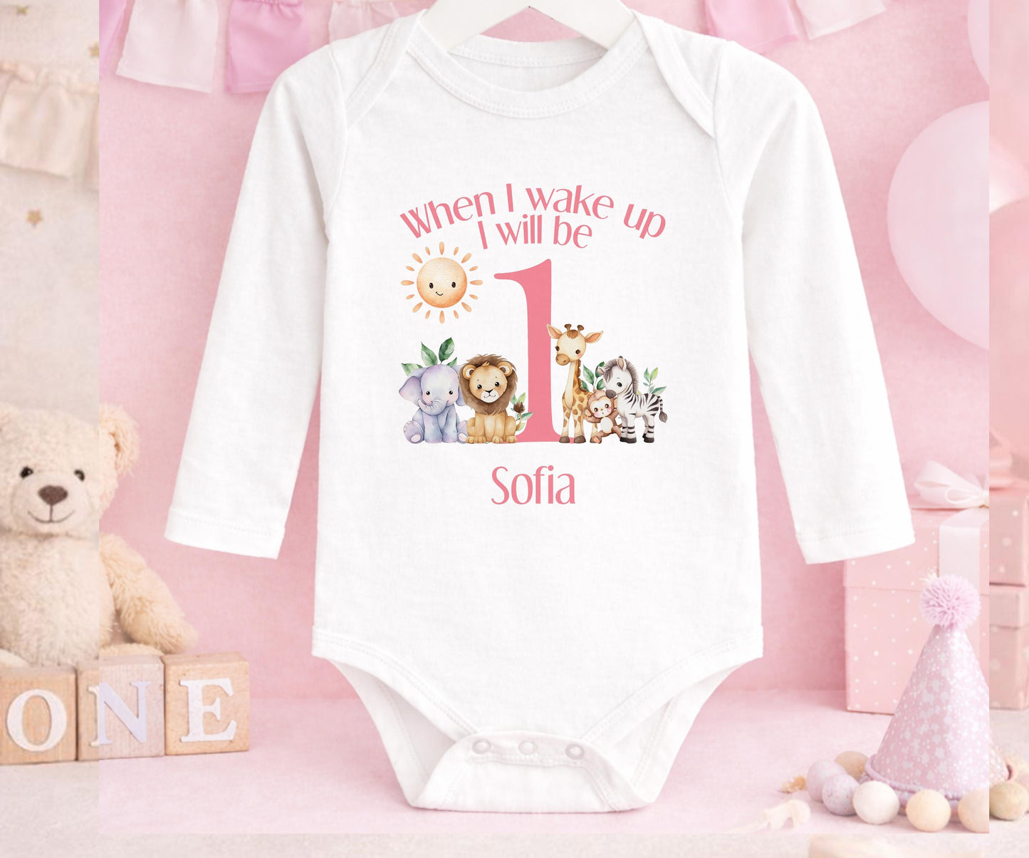 Close-up of the safari design and custom name print on pink 1st birthday pyjamas