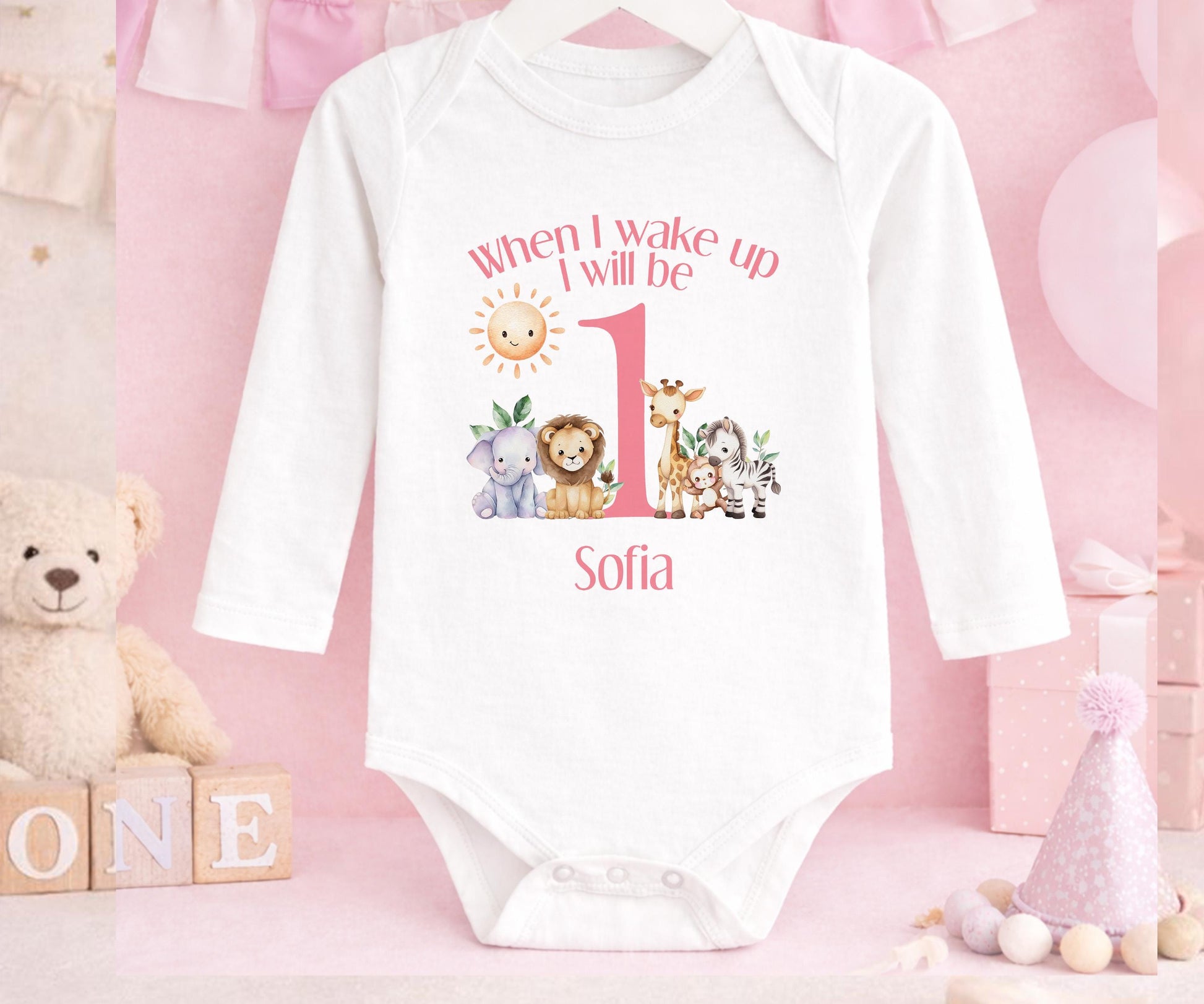 Close-up of the safari design and custom name print on pink 1st birthday pyjamas
