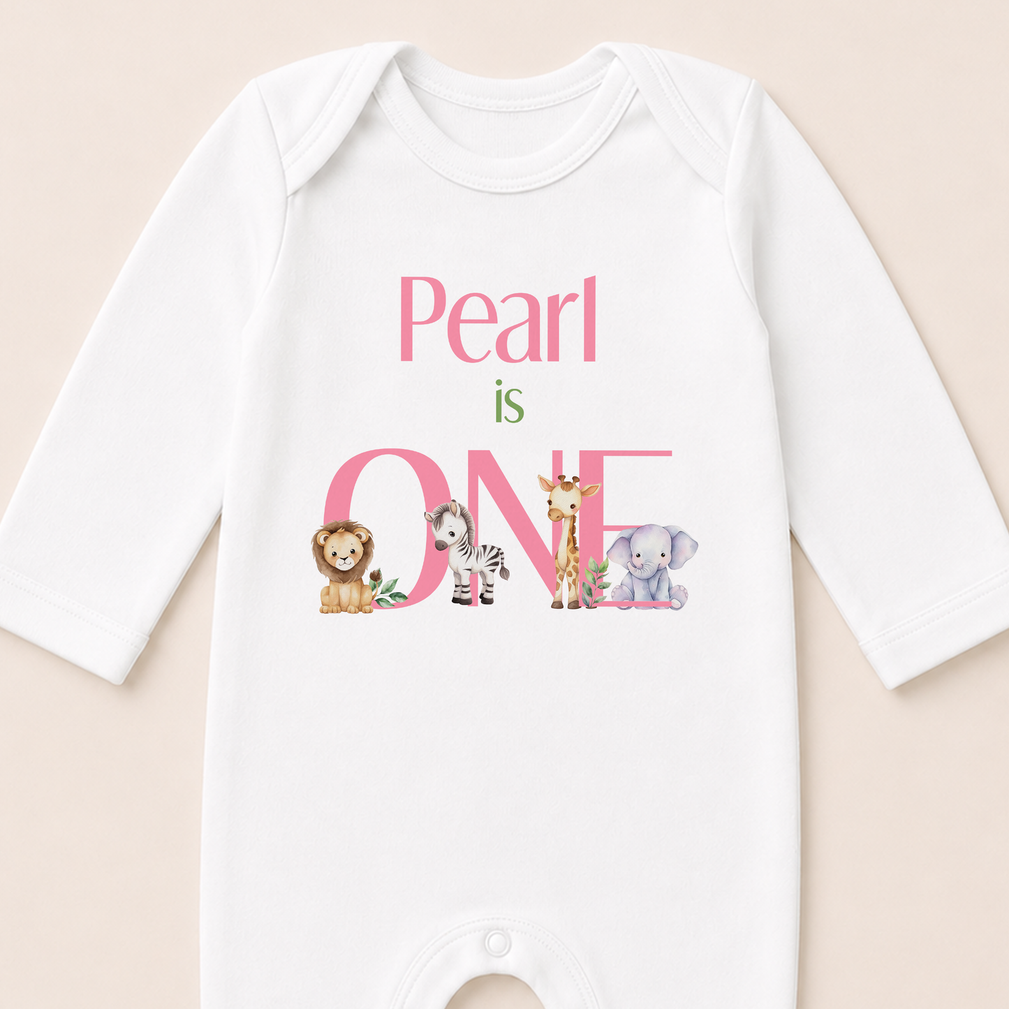 Close-up of the safari first birthday vest showing the pink personalised text and animal illustrations.