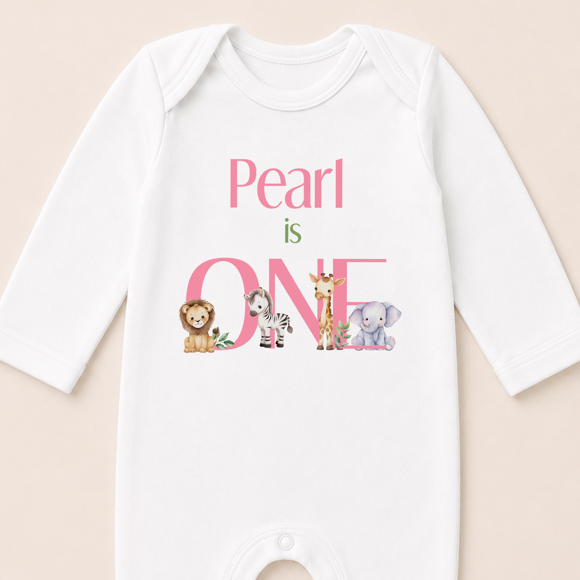 Close-up of the safari first birthday vest showing the pink personalised text and animal illustrations.