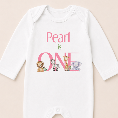 Close-up of the safari first birthday vest showing the pink personalised text and animal illustrations.