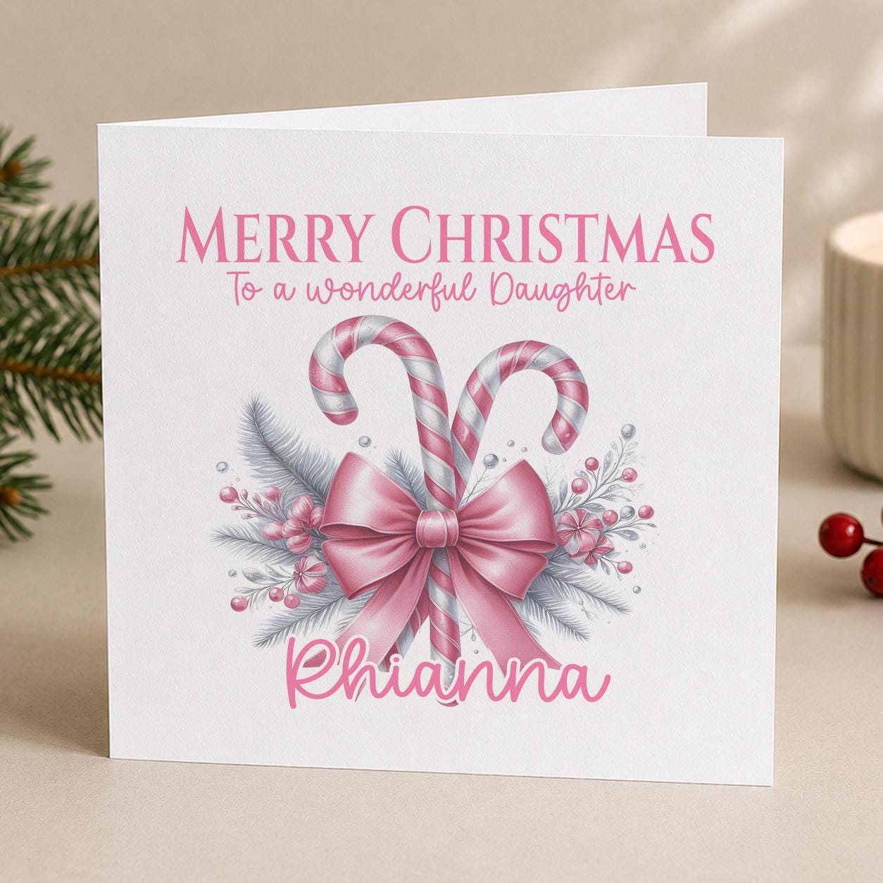 Close up of the personalised pink bow Christmas card showing the Merry Christmas wording, relation and name