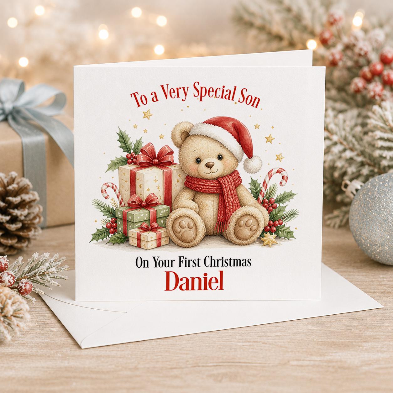 Personalised first Christmas card, white 6x6 inch square card printed with a teddy bear in a red jumper and presents with a name