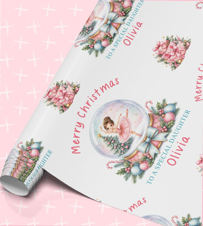 Personalised ballerina Christmas wrapping paper, part-rolled sheet printed with pink snow globes and Merry Christmas with a name