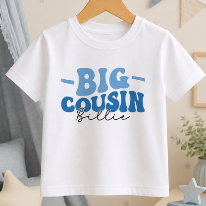 A white t-shirt with the text "BIG COUSIN BILLIE" printed on it.
