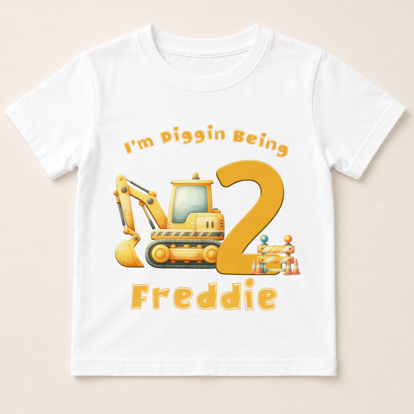 A white t-shirt with a cartoon construction vehicle and the text "I'm Piggin Being 2" printed on it.