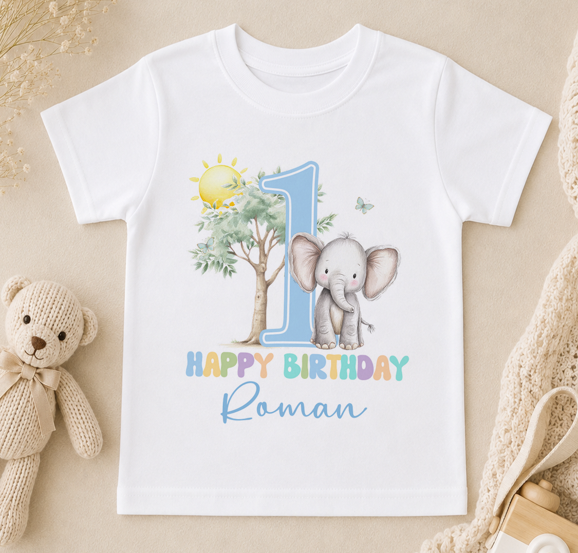 A white t-shirt with a colorful graphic design featuring an elephant and the number 1, along with the text "Happy Birthday Roman".