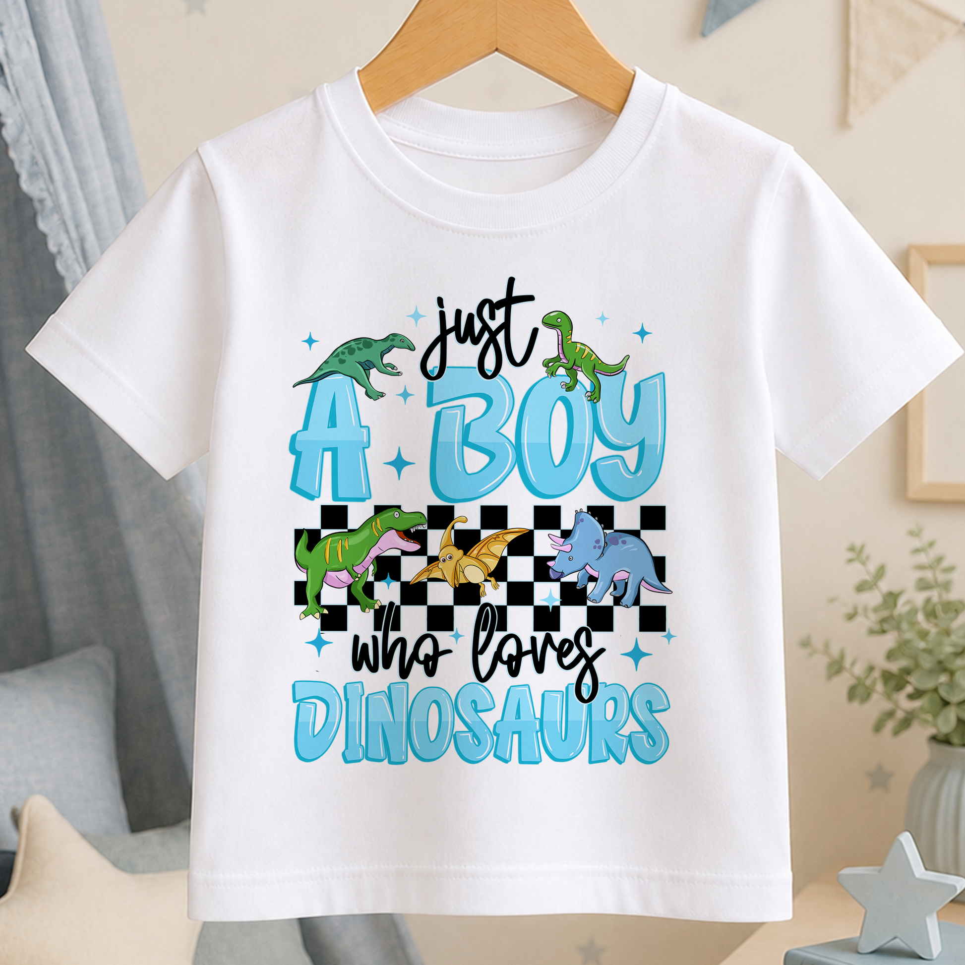 A white t-shirt with a graphic design featuring a dinosaur and the text "Just a boy who loves dinosaurs".