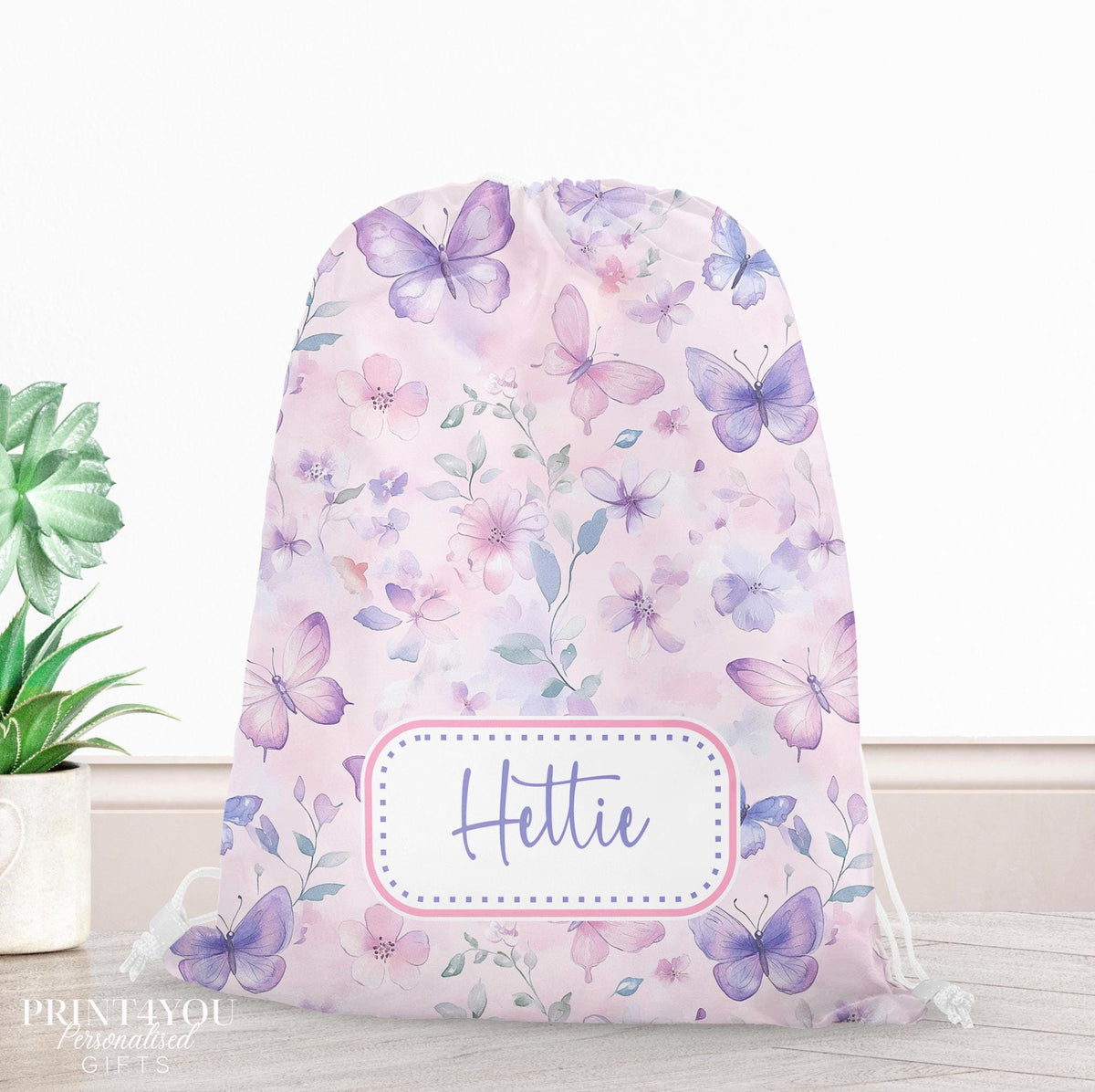 Personalised pastel watercolour butterfly drawstring PE bag with a child's name printed on the front