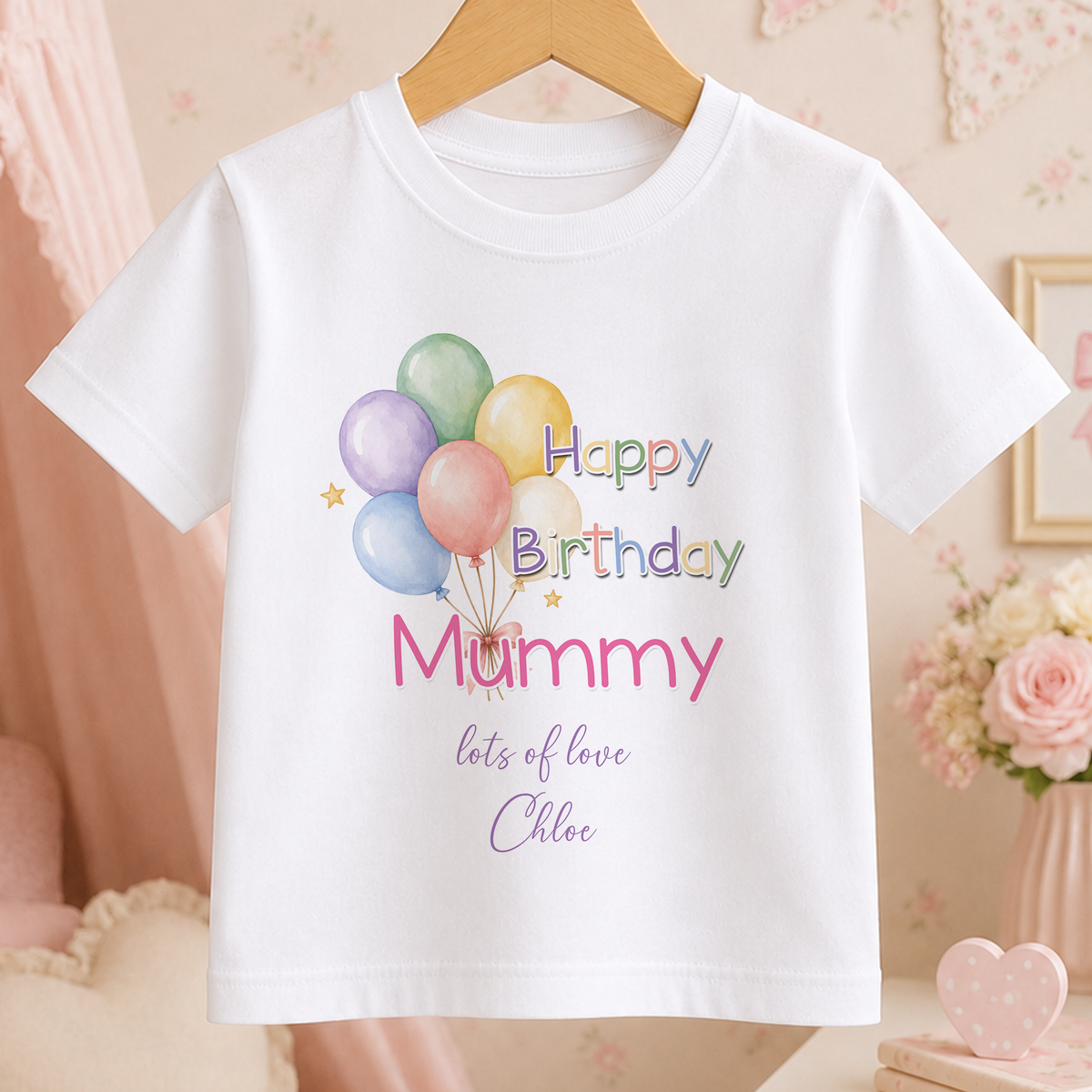 A white t-shirt with a birthday message printed on it, featuring colorful balloons and the text "Happy Birthday Mummy lots of love Chloe".