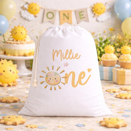 Personalised sunshine birthday sack laid flat, showing the printed name and sunbeam design
