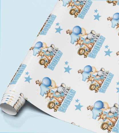 The image is a roll of wrapping paper with a repeating pattern of cartoon animal illustrations, including elephants, lions, and other animals, along with blue balloons and stars.