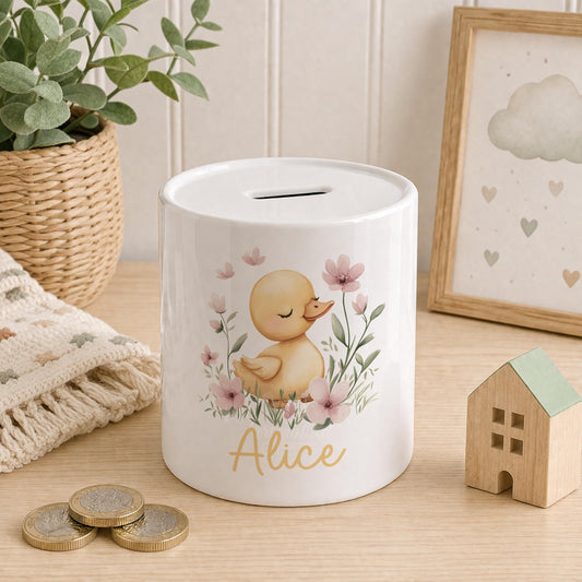 Ceramic money box printed with a personalised duckling and floral nursery design
