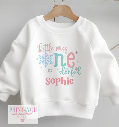 Close-up of the pastel snowflake print and personalised name on the Little Miss ONEDERFUL first birthday outfit, size 6-12 months