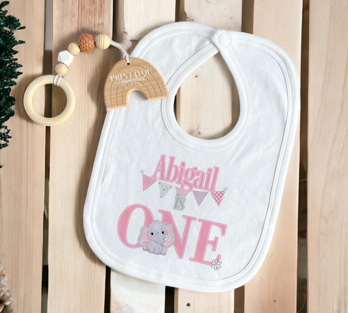 Close-up of the pink bunting and baby elephant print, personalised with baby's name.