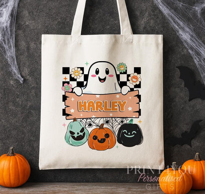 Cotton tote bag printed with a retro ghost, checkerboard background and colourful pumpkins, personalised with a custom name banner.