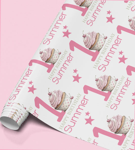 a roll of wrapping paper with a repeating pattern of pink cupcakes and stars, along with the text "Happy Summer 1st Birthday".