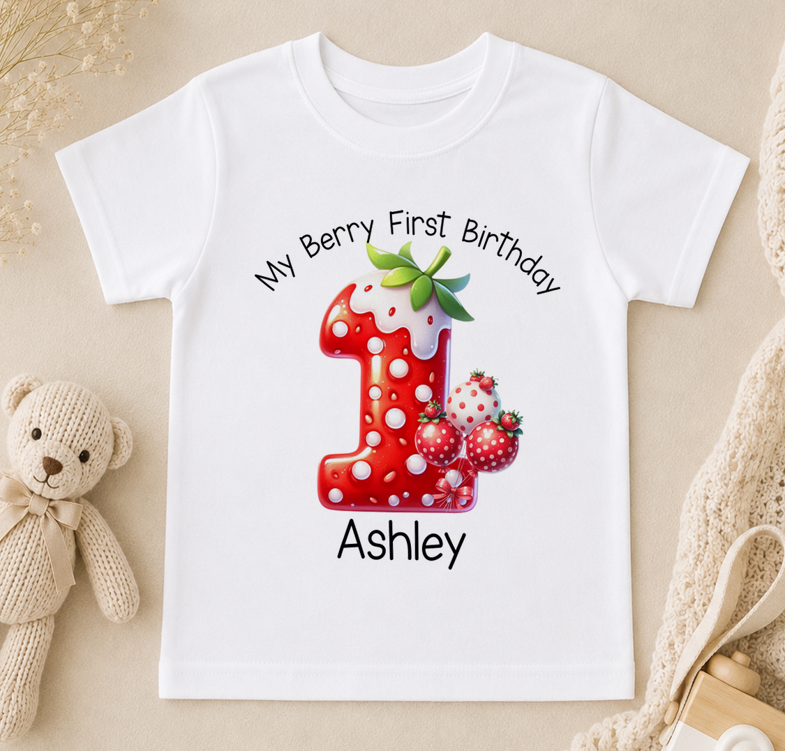White t-shirt printed with a red number 1, strawberries and the text 'My Berry First Birthday Ashley'.