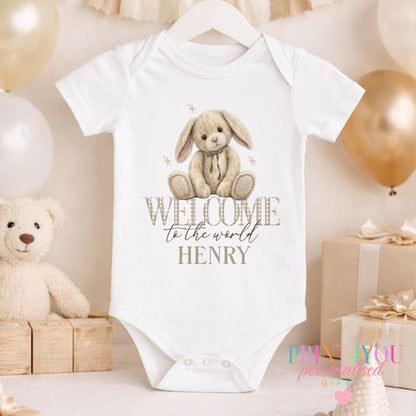 Close-up of the welcome to the world bunny design and personalised name on the newborn vest.