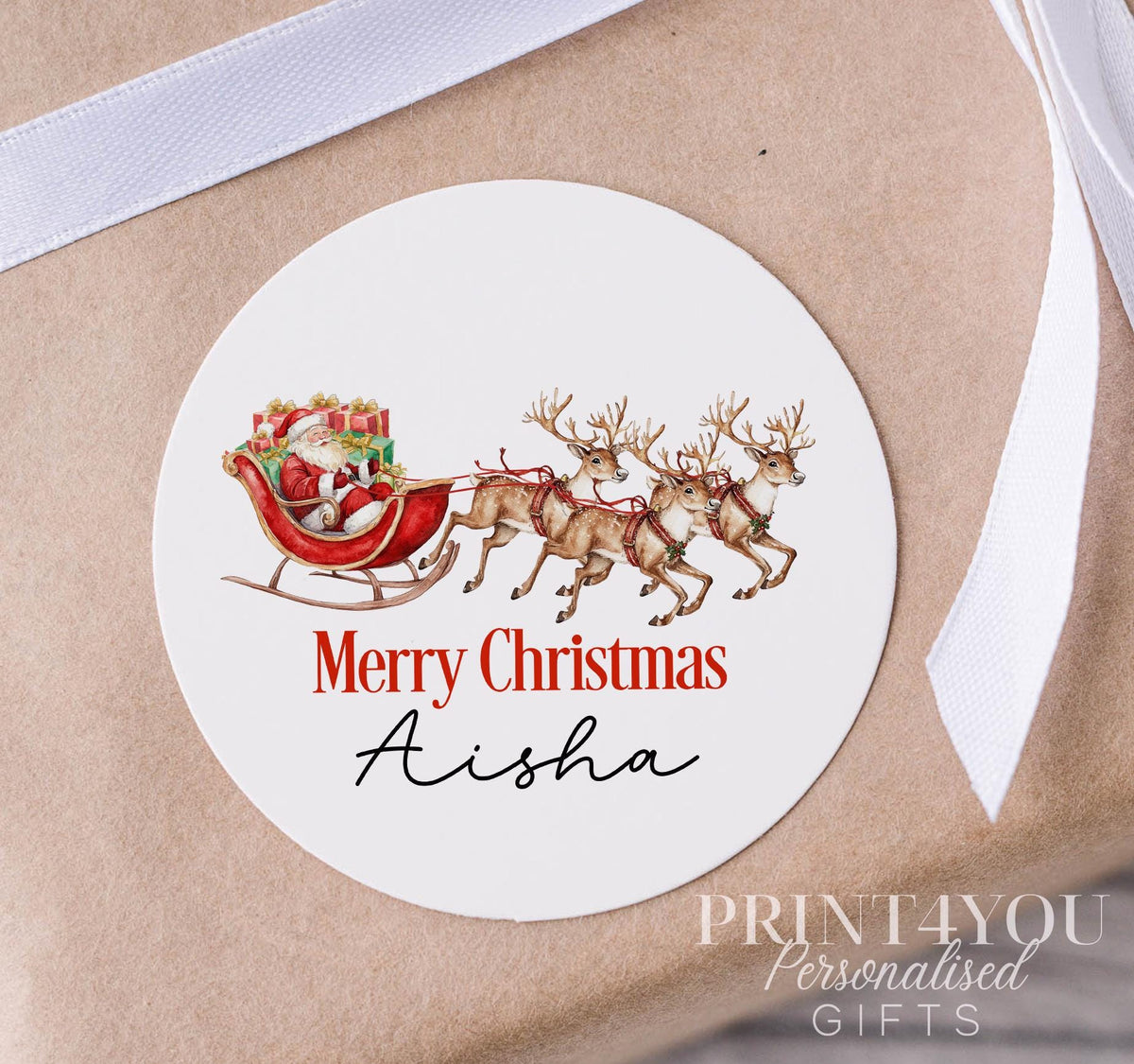 Personalised glossy white water-resistant Christmas sticker featuring Santa's sleigh design, custom name printed, shown on a strip of 5cm stickers
