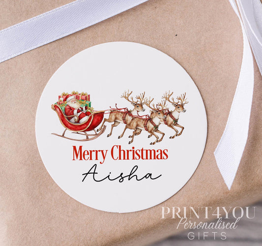 Personalised glossy white water-resistant Christmas sticker featuring Santa's sleigh design, custom name printed, shown on a strip of 5cm stickers