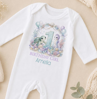 Personalised first birthday outfit in white with a watercolour sea turtle, seahorse and pastel balloons, Birthday Girl with a name and age