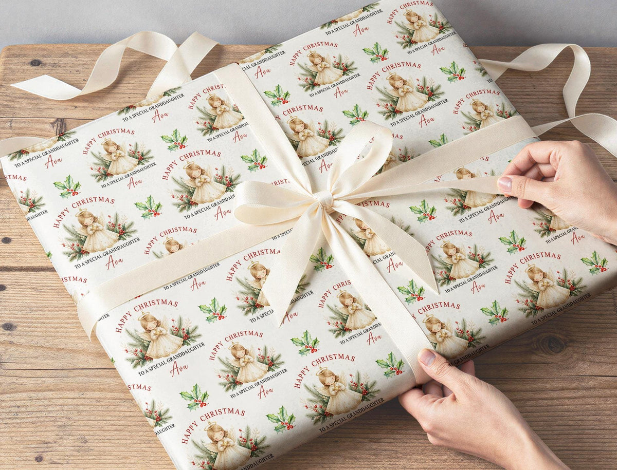 Sheets of the personalised angel Christmas wrapping paper folded ready to wrap