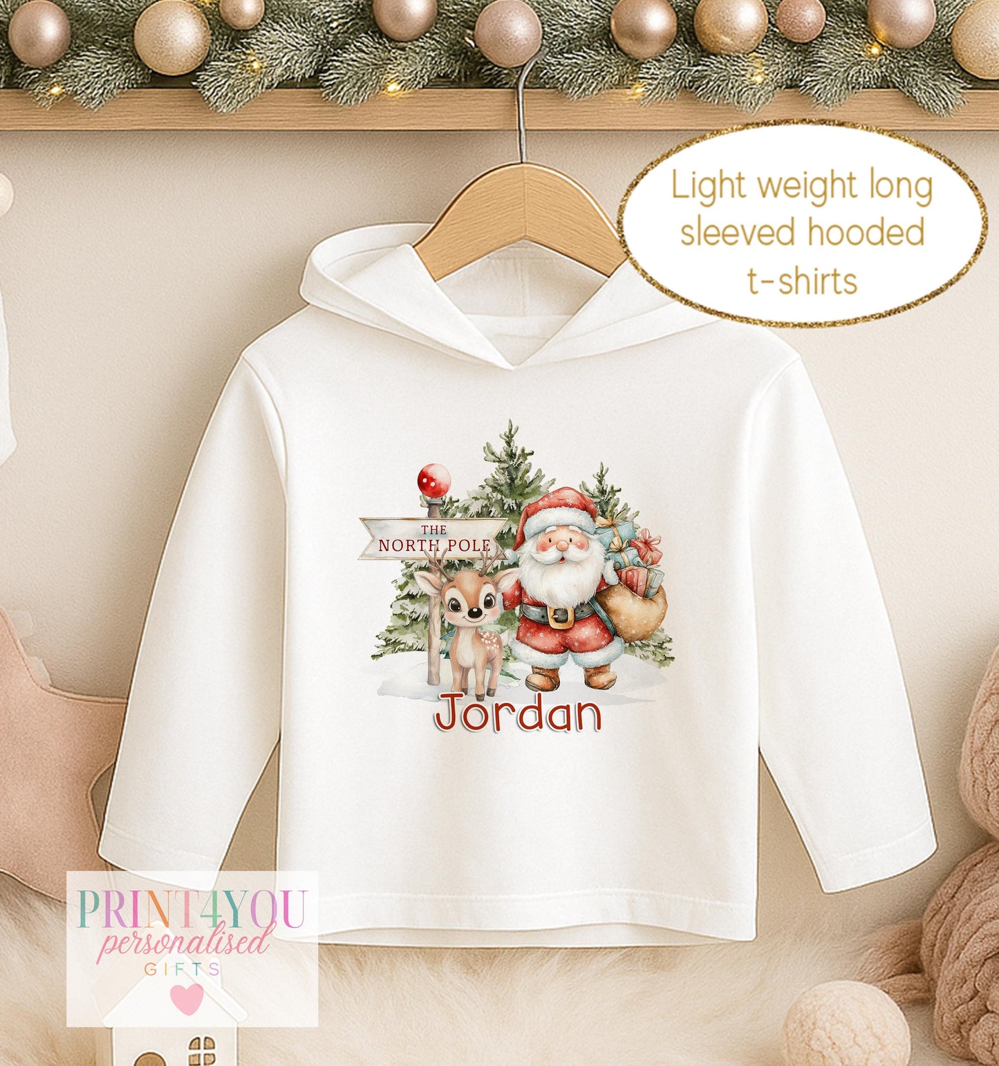 Personalised Christmas hooded t-shirt, white long sleeved hoodie printed with Santa and a reindeer at the North Pole and a name in blue