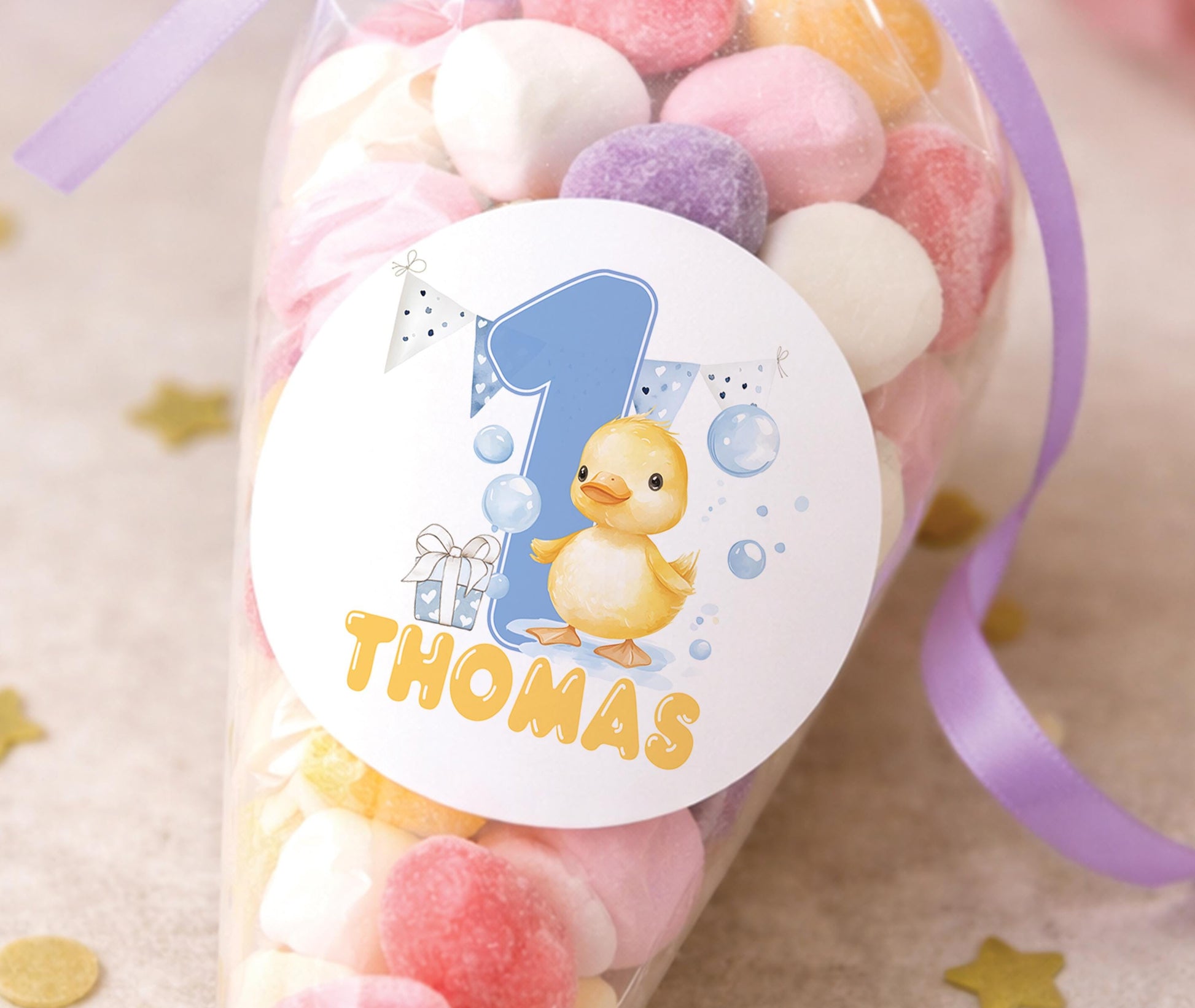 Sheet of glossy personalised 1st birthday duck stickers featuring cartoon ducks and party bunting, ready for a baby boy's birthday party bags